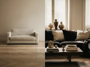 Woonkamer met minimalistische linnen bank op eiken visgraatparket naast fluwelen kussens, keramiek en kunstboeken in warm ivoor en houtskool.